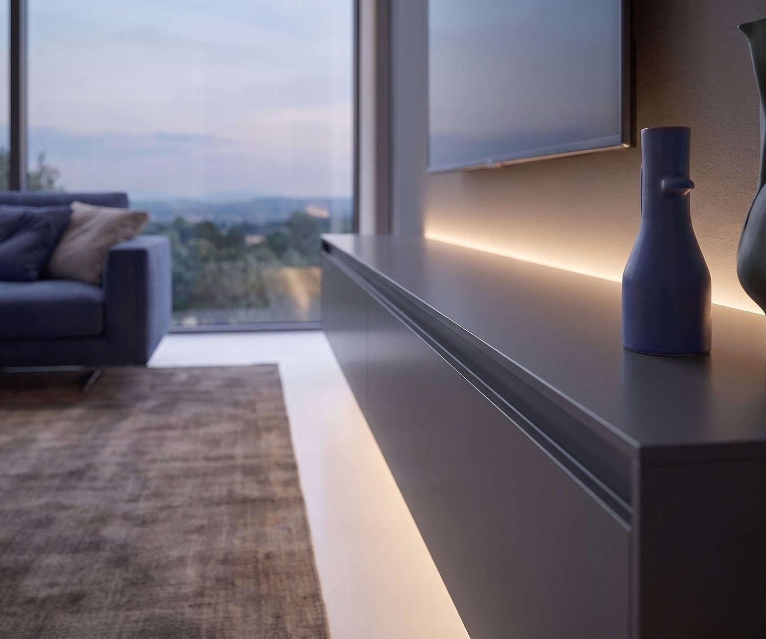 Meuble TV suspendu Reverse de Novamobili dans un salon. Banc TV design gris moderne avec un éclairage LED chaleureux.