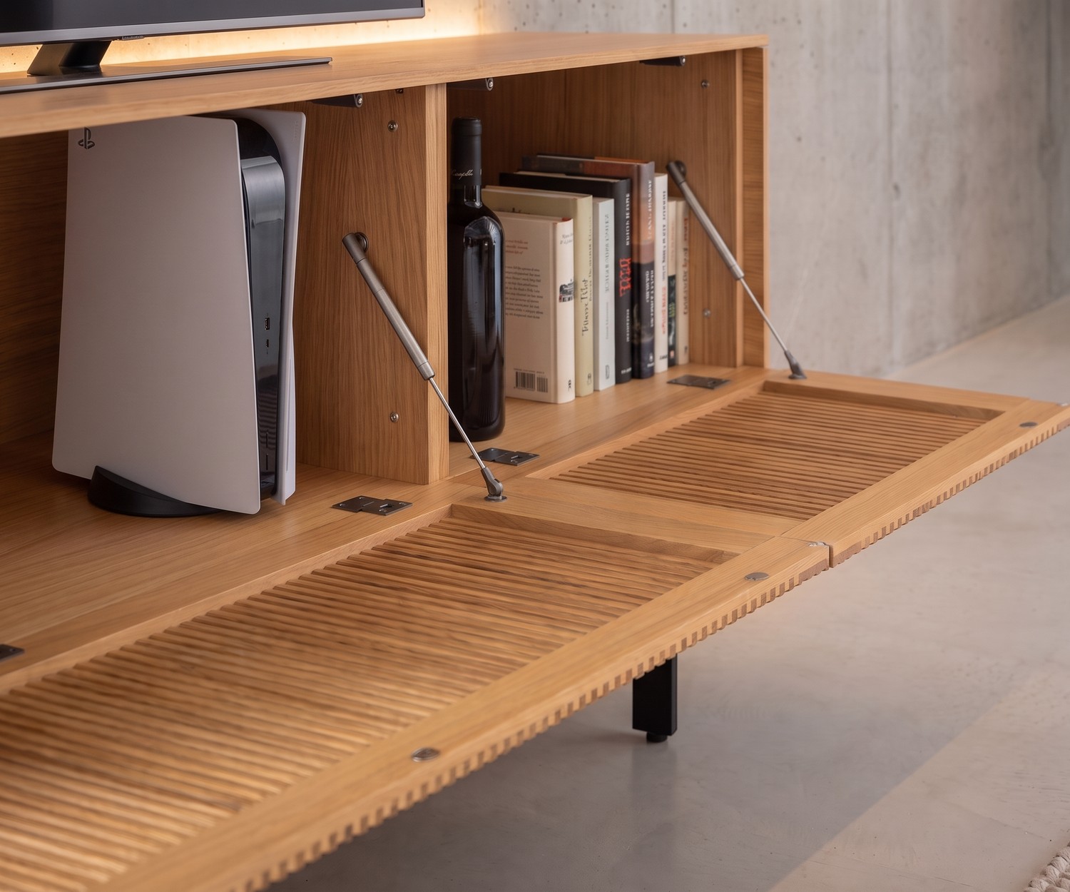 Meuble TV Lowboard Punt Malmö en Chêne à Porte Abattante Meuble TV lowboard Punt Malmö en chêne avec porte abattante à claire-voie et rangement pour console dans un salon moderne.